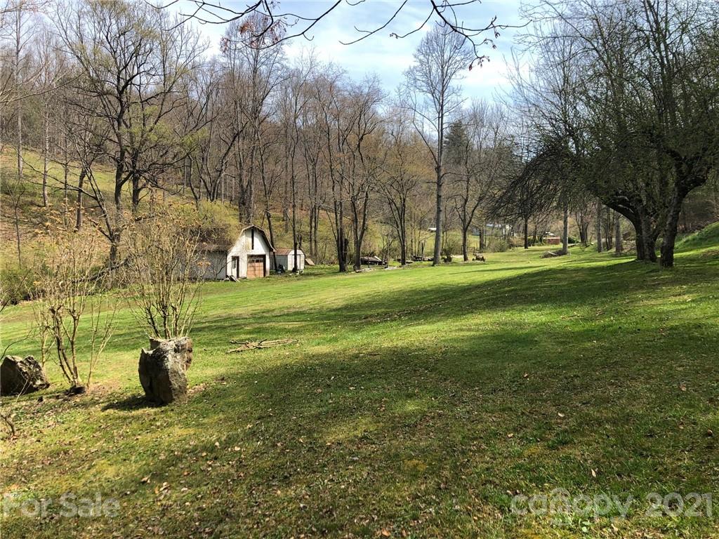 289 Long Branch Road Clyde, NC 28721 - Photo 39 of 44 a big yard with flowing stream of water in front of it