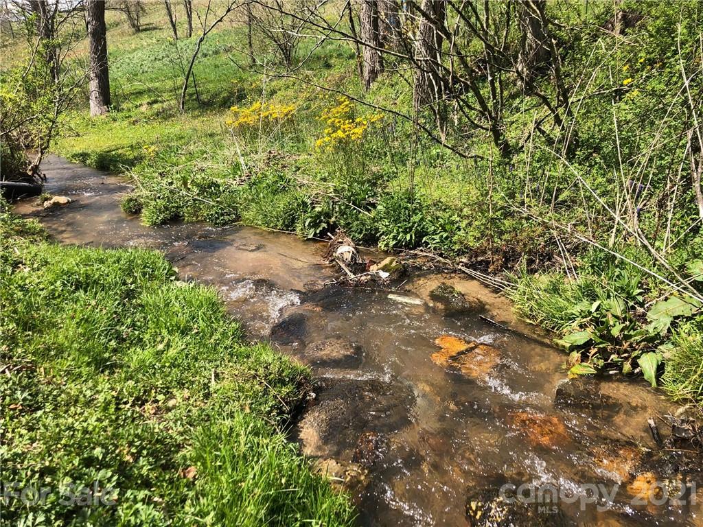 289 Long Branch Road Clyde, NC 28721 - Photo 41 of 44 a backyard of a house with a yard and outdoor seating