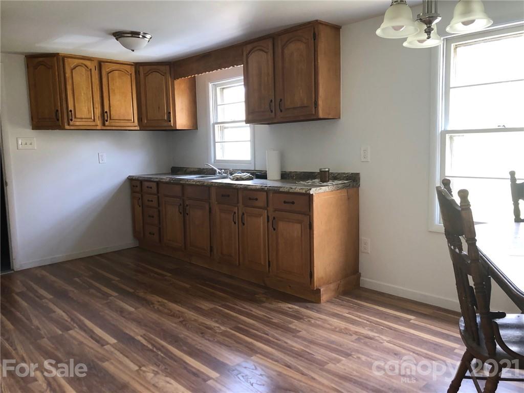 289 Long Branch Road Clyde, NC 28721 - Photo 7 of 44 a kitchen with a stove a refrigerator and cabinet