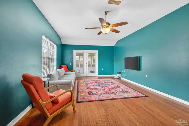 a living room with furniture and a flat screen tv