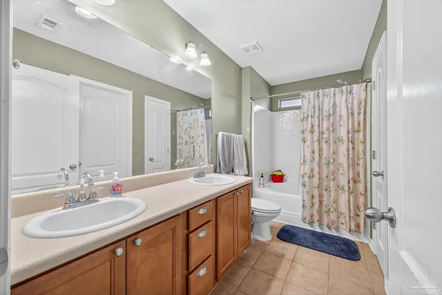 a bathroom with a sink double vanity and a mirror