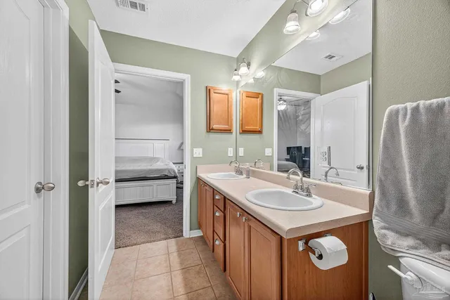 a bathroom with a sink a mirror and a bath tub