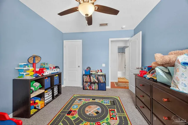 a bed room with a bed and a wooden floor