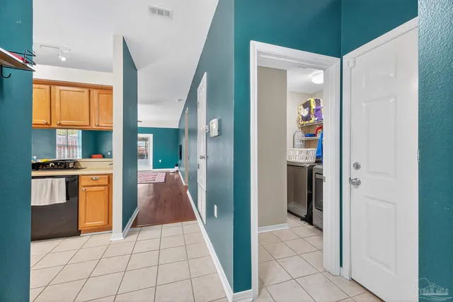 a view of kitchen with stainless steel appliances granite countertop refrigerator and stove