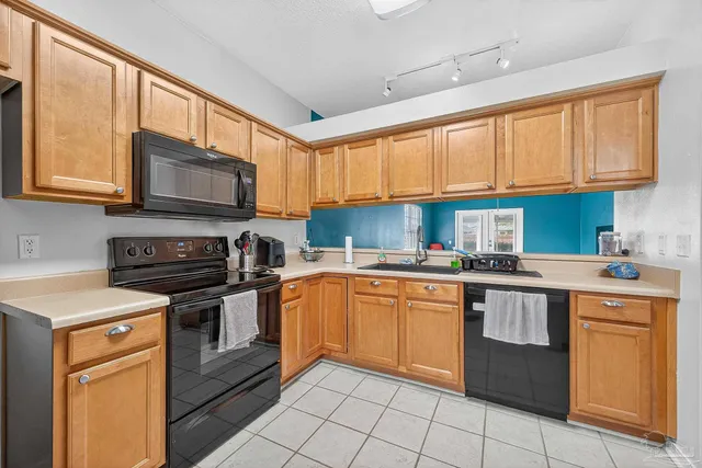 a kitchen with stainless steel appliances granite countertop a stove sink microwave and cabinets