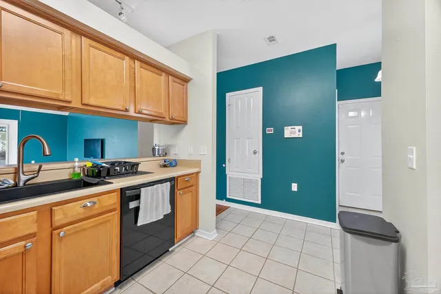 a kitchen with a sink cabinets and appliances