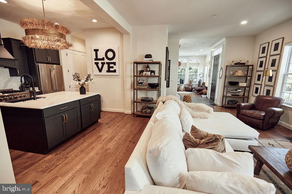 6306 Canter Way, Unit 13 Baltimore, MD 21212 - Photo 13 of 63 a living room with furniture a flat screen tv and a wooden floor
