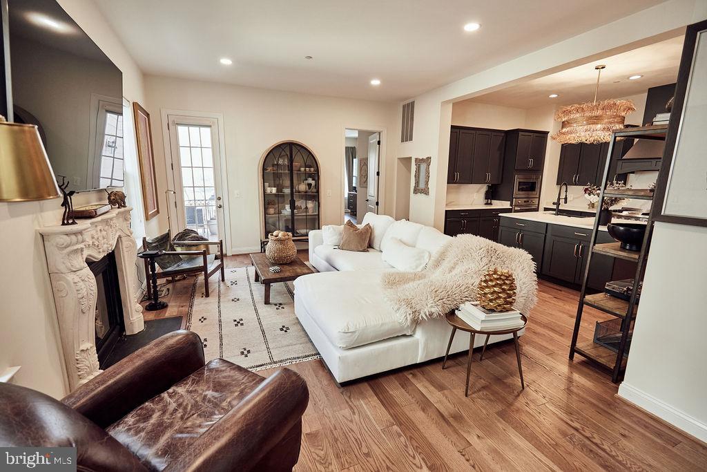 6306 Canter Way, Unit 13 Baltimore, MD 21212 - Photo 14 of 63 a living room with furniture a fireplace and a flat screen tv
