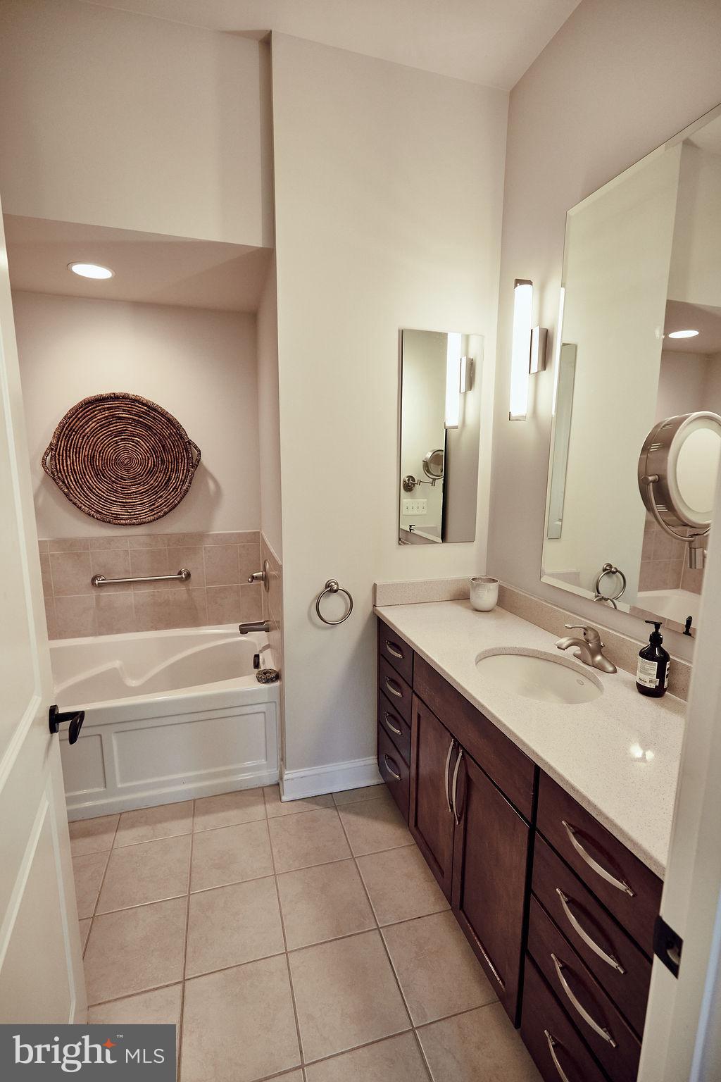 6306 Canter Way, Unit 13 Baltimore, MD 21212 - Photo 22 of 63 a spacious bathroom with a sink a vanity and a mirror