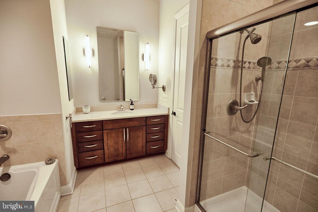 6306 Canter Way, Unit 13 Baltimore, MD 21212 - Photo 24 of 63 a bathroom with a granite countertop sink mirror and shower