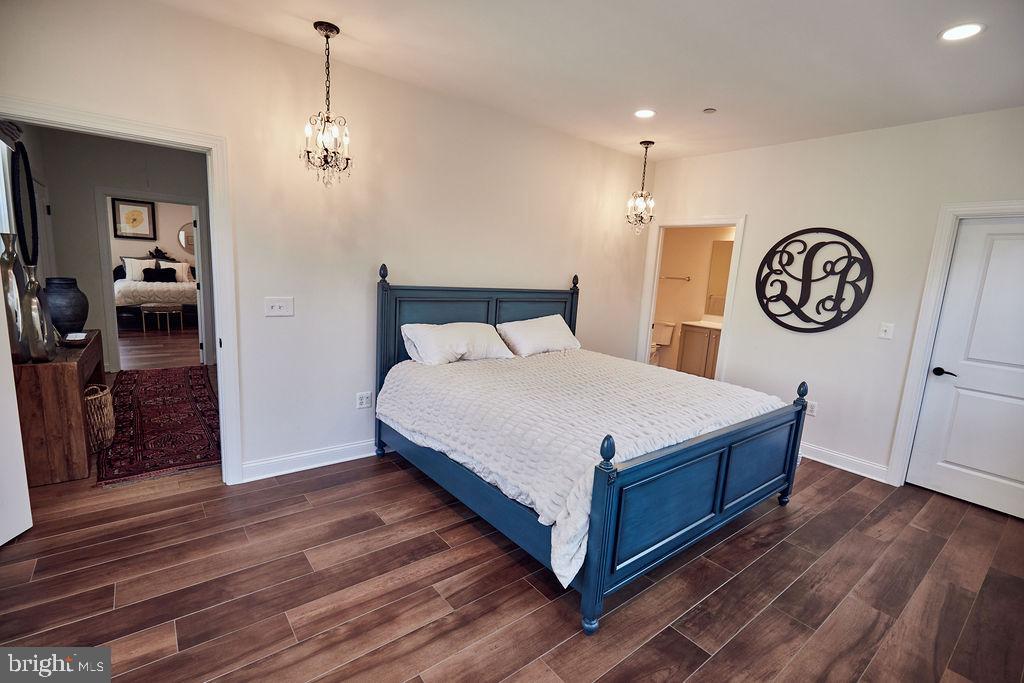 6306 Canter Way, Unit 13 Baltimore, MD 21212 - Photo 30 of 63 a bedroom with a bed and wooden floor