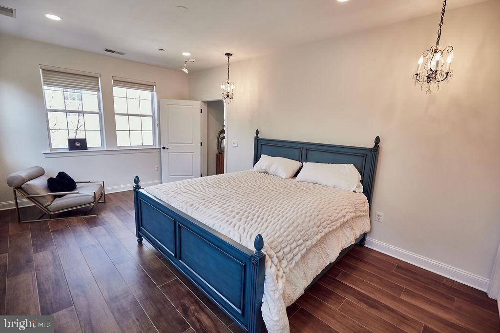 6306 Canter Way, Unit 13 Baltimore, MD 21212 - Photo 31 of 63 a spacious bedroom with a bed and wooden floor