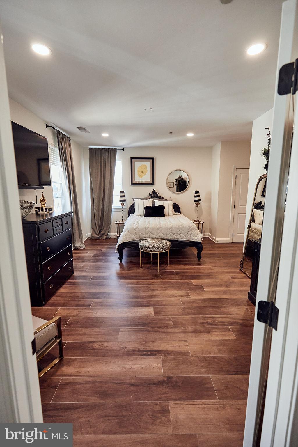 6306 Canter Way, Unit 13 Baltimore, MD 21212 - Photo 35 of 63 a bedroom with furniture and a flat screen tv