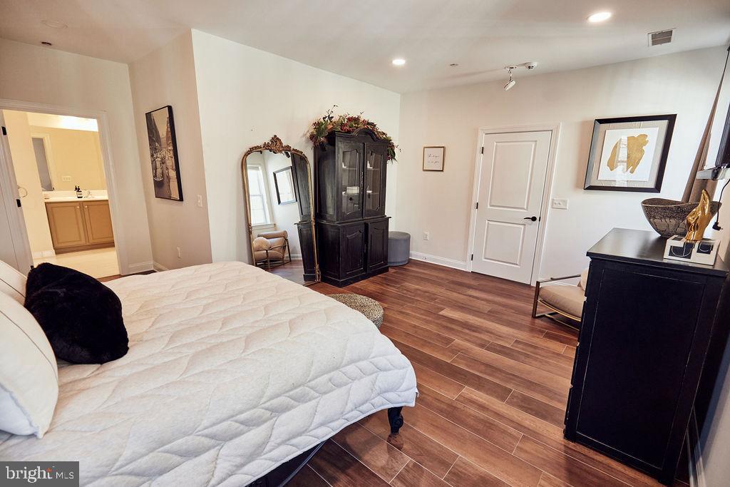 6306 Canter Way, Unit 13 Baltimore, MD 21212 - Photo 37 of 63 a bedroom with a bed and a dresser