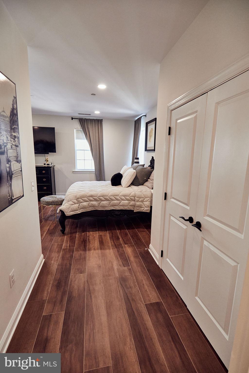 6306 Canter Way, Unit 13 Baltimore, MD 21212 - Photo 39 of 63 a bedroom with a bed and wooden floor