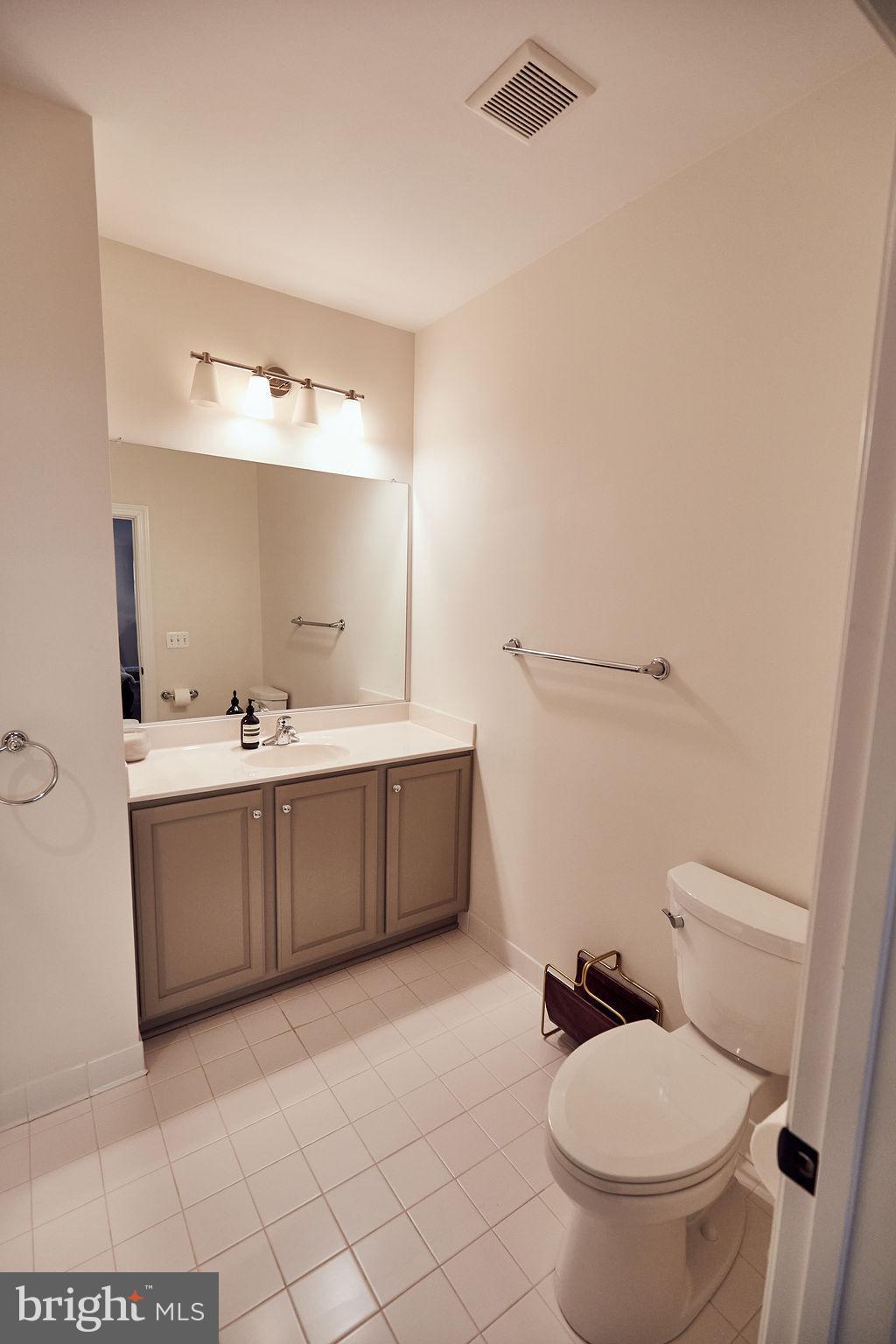 6306 Canter Way, Unit 13 Baltimore, MD 21212 - Photo 40 of 63 a bathroom with a sink a toilet and mirror