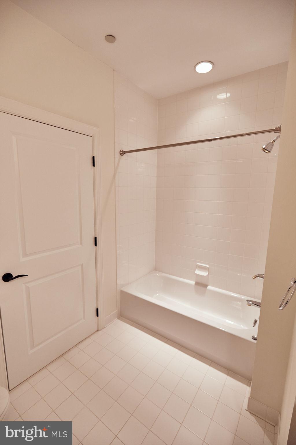 6306 Canter Way, Unit 13 Baltimore, MD 21212 - Photo 41 of 63 a bathroom with a bathtub and a shower