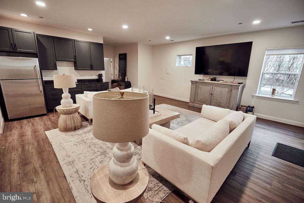 6306 Canter Way, Unit 13 Baltimore, MD 21212 - Photo 46 of 63 a living room with furniture and a flat screen tv