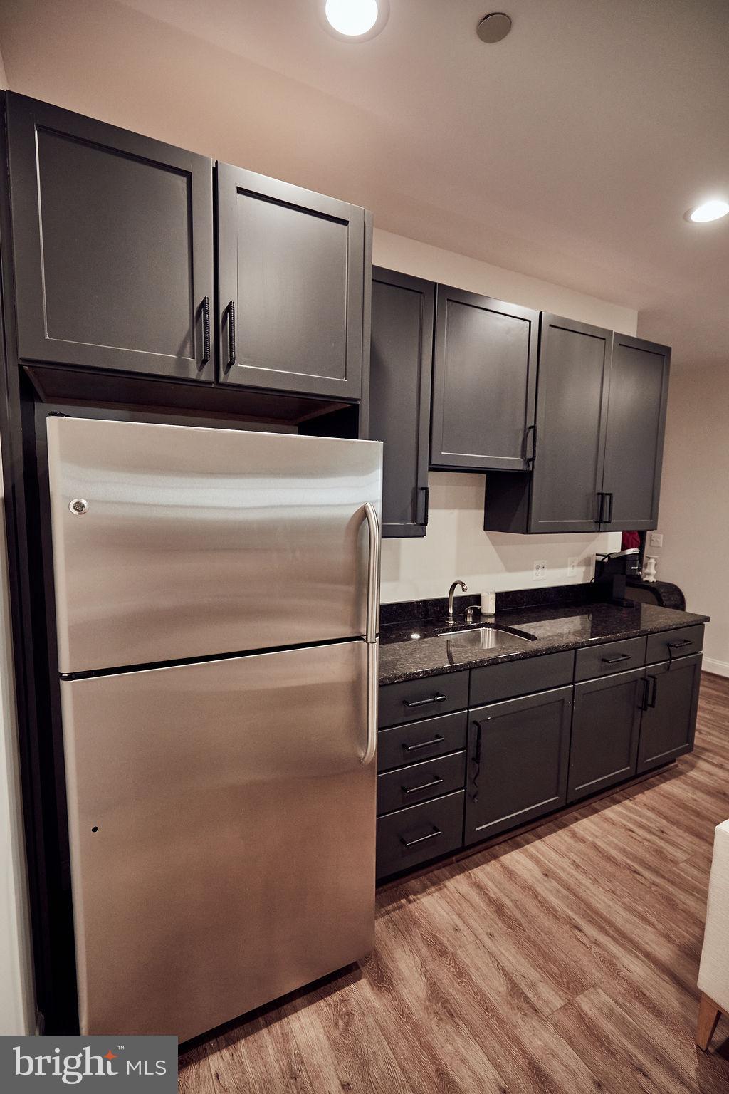 6306 Canter Way, Unit 13 Baltimore, MD 21212 - Photo 47 of 63 a kitchen with stainless steel appliances granite countertop a refrigerator and a stove top oven