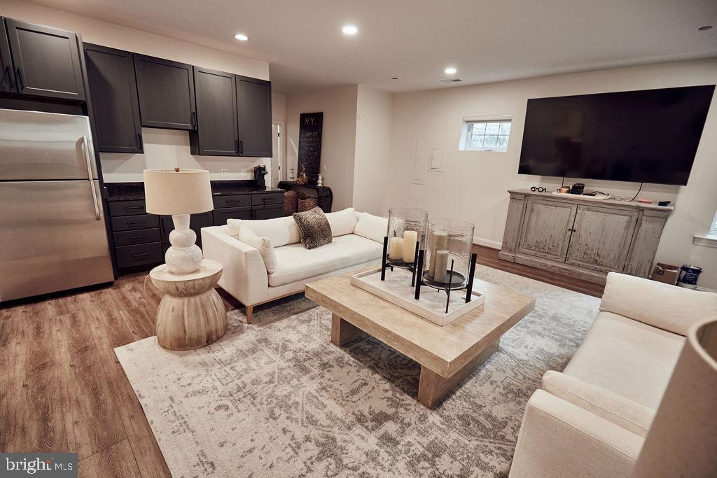 6306 Canter Way, Unit 13 Baltimore, MD 21212 - Photo 48 of 63 a living room with furniture and a flat screen tv