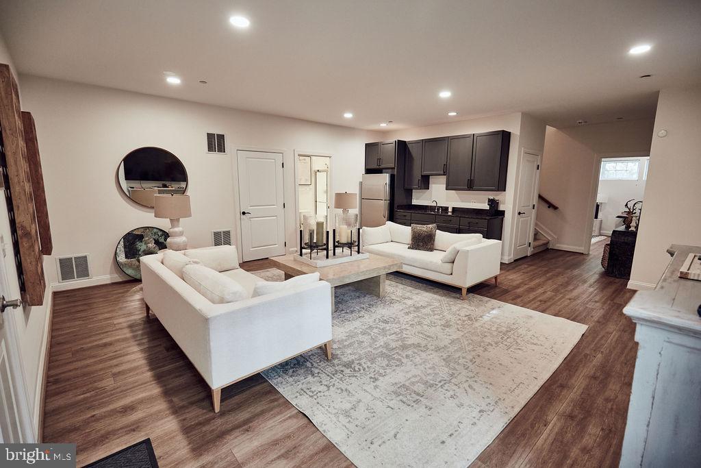 6306 Canter Way, Unit 13 Baltimore, MD 21212 - Photo 49 of 63 a living room with furniture and a wooden floor