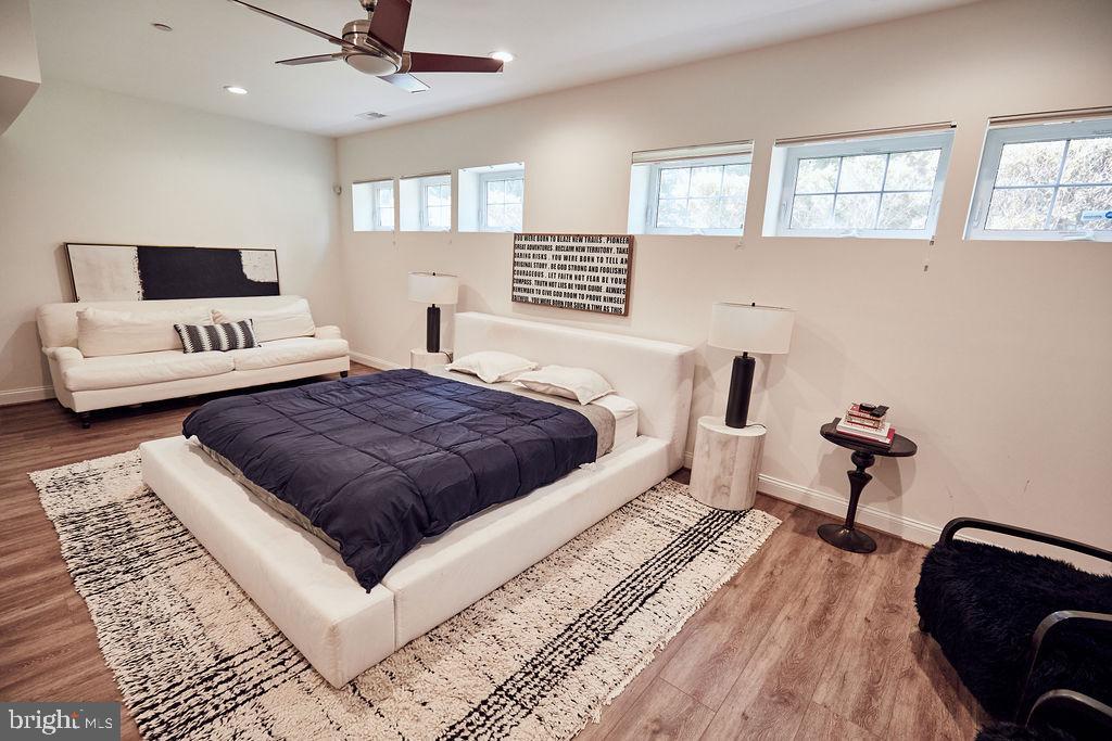 6306 Canter Way, Unit 13 Baltimore, MD 21212 - Photo 50 of 63 a spacious bedroom with a bed and a couch