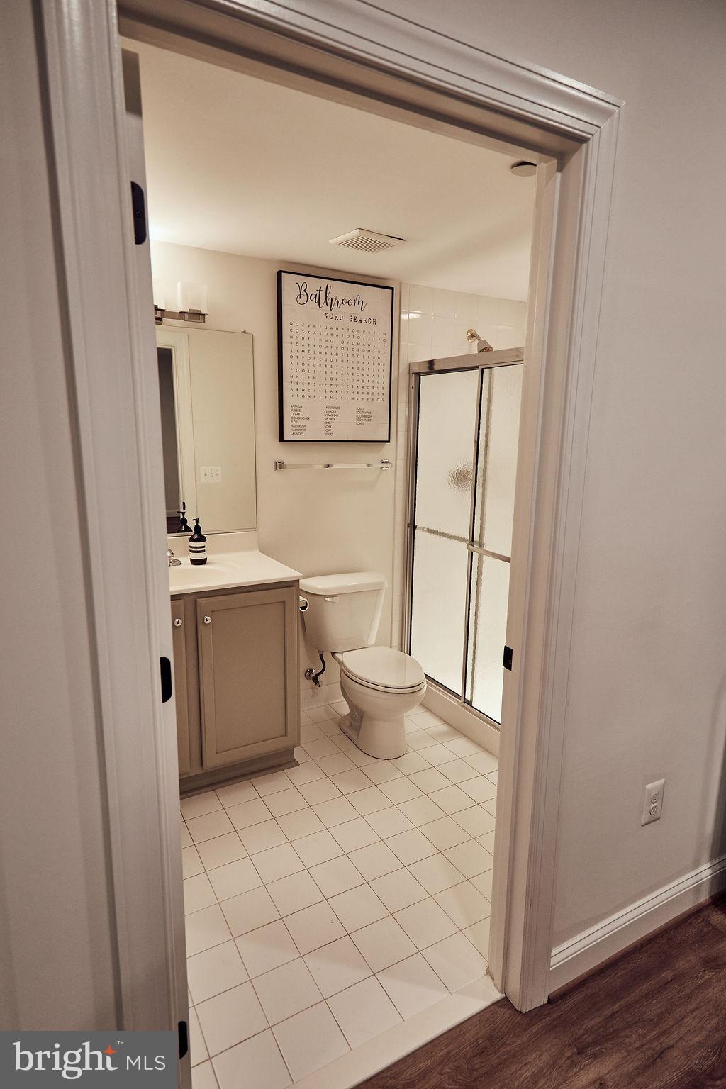 6306 Canter Way, Unit 13 Baltimore, MD 21212 - Photo 54 of 63 a bathroom with a sink a toilet and mirror