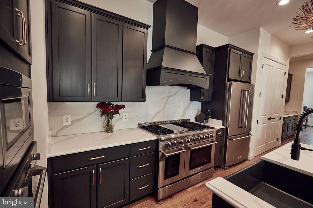 6306 Canter Way, Unit 13 Baltimore, MD 21212 - Photo 9 of 63 a kitchen with stainless steel appliances a refrigerator and a stove