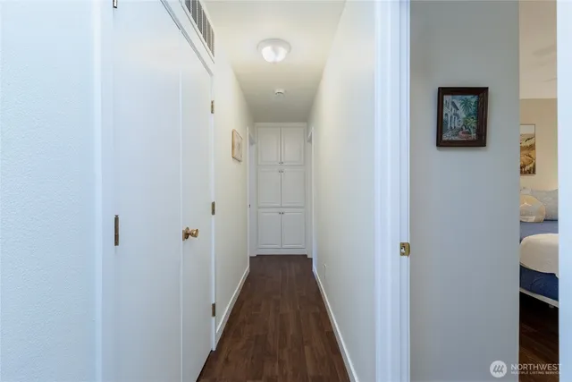 a view of a hallway with a hardwood and door
