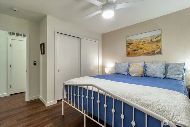 a bedroom with a bed and wooden floor