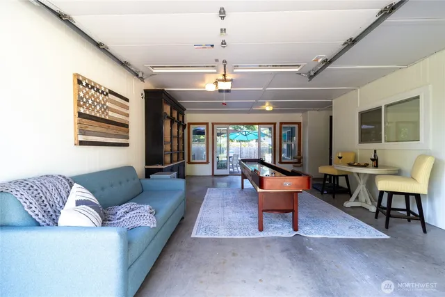 a living room with furniture and a chandelier