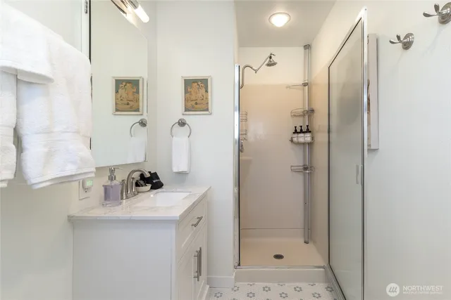 a bathroom with a sink mirror toilet and shower