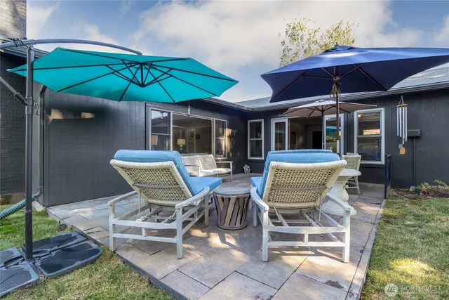 a patio with a patio table and chairs