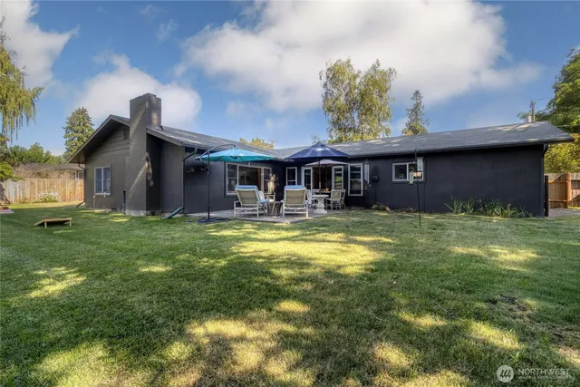 a front view of a house with a yard table and chairs