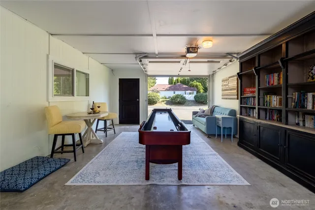 a living room with furniture a rug and a flat screen tv