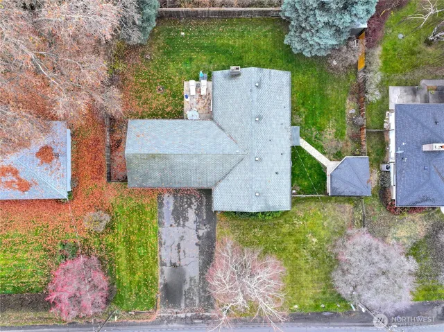an aerial view of a house with garden space and street view