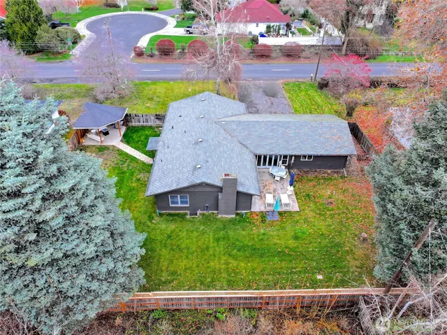 an aerial view of house with yard swimming pool and outdoor seating