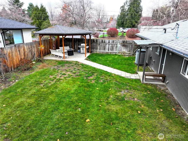 a view of a house with backyard porch and sitting area