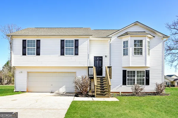 a front view of a house with a yard