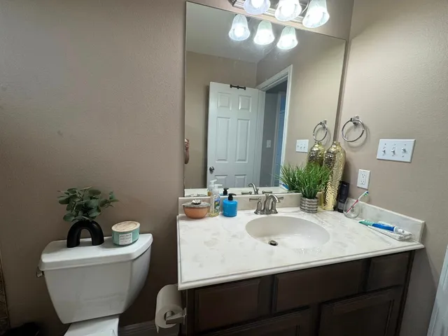 a bathroom with a sink mirror and vanity