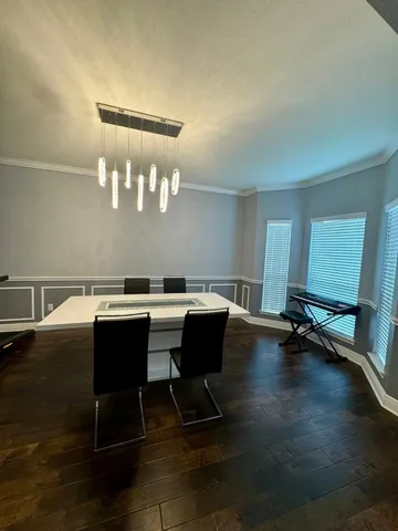 a room with wooden floor and windows