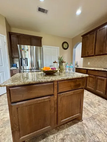 a kitchen with stainless steel appliances granite countertop a sink stove and cabinets