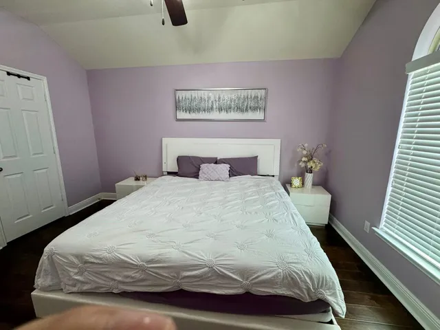 a bedroom with a bed and window