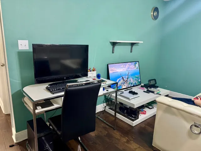 a bedroom with a bed and a painting on the wall