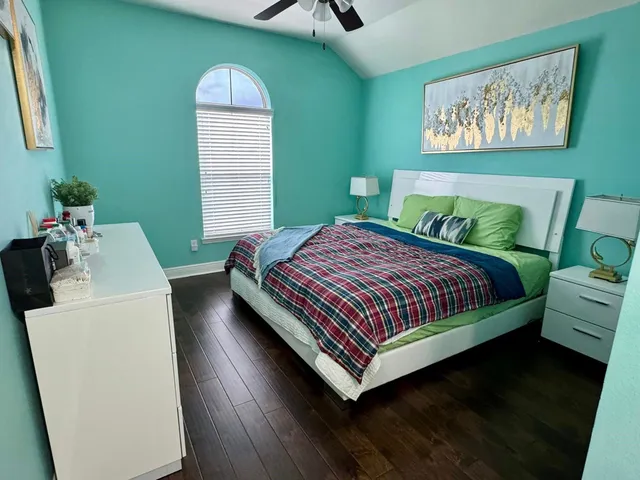 a bathroom with a granite countertop sink a toilet and a mirror