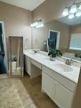 a bedroom with a bed table and window