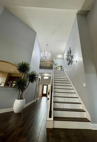 a view of entryway and hall with wooden floor