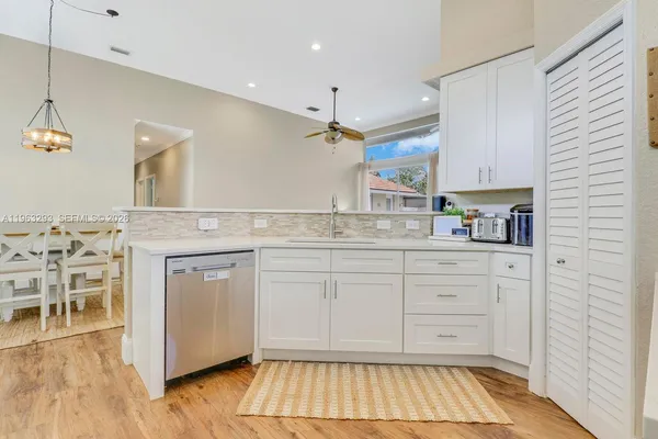 a kitchen with a sink cabinets and wooden floor