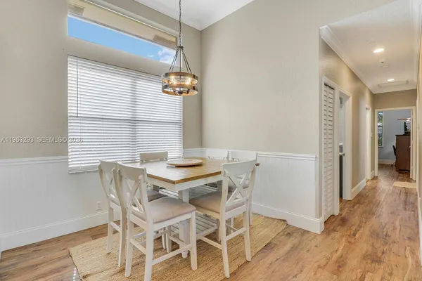 a view of a dining room with furniture and wooden floor