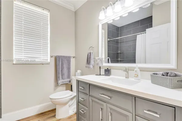 a bathroom with a sink toilet and mirror